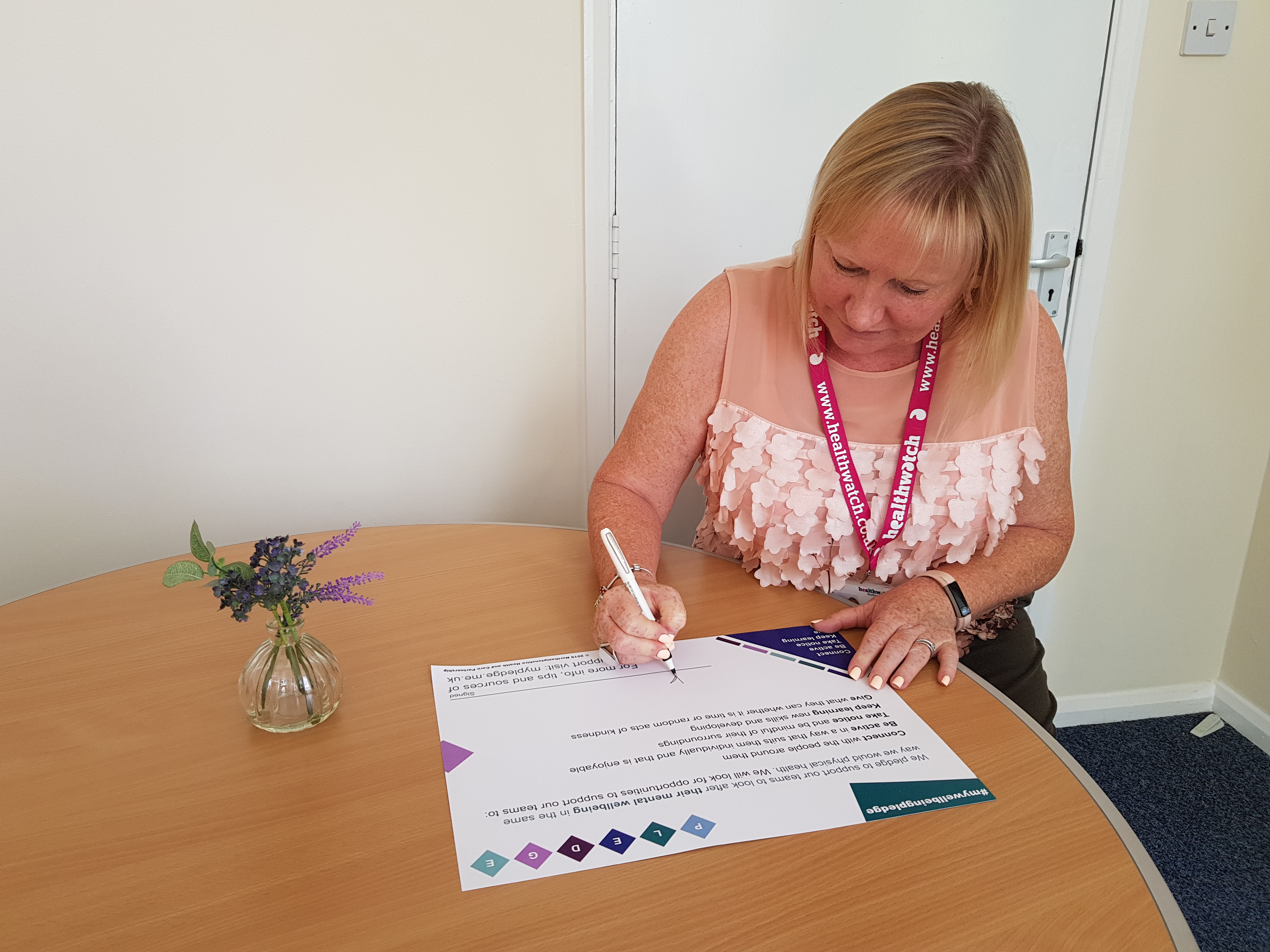 Kate Holt, CEO of Healthwatch Northamptonshire and Connected Together CIC, signing the wellbeing pledge.