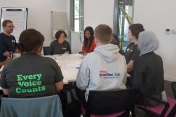 young healthwatch and northamptonshire young carers around a table at a meeting 