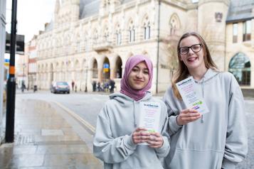 young healthwatch volunteers holding leaflets 