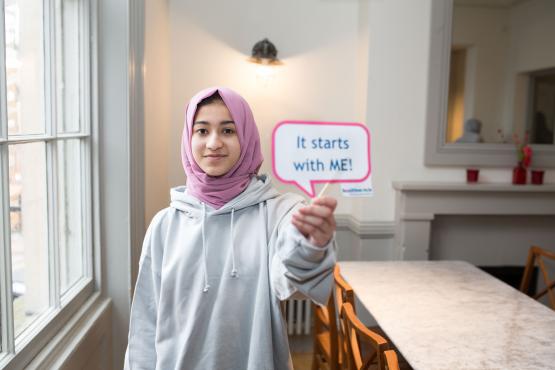 Young person - holding sign- it starts with me