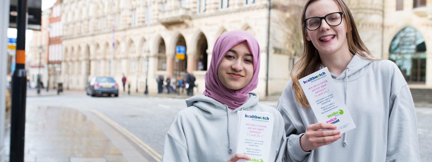 young healthwatch volunteers holding leaflets 