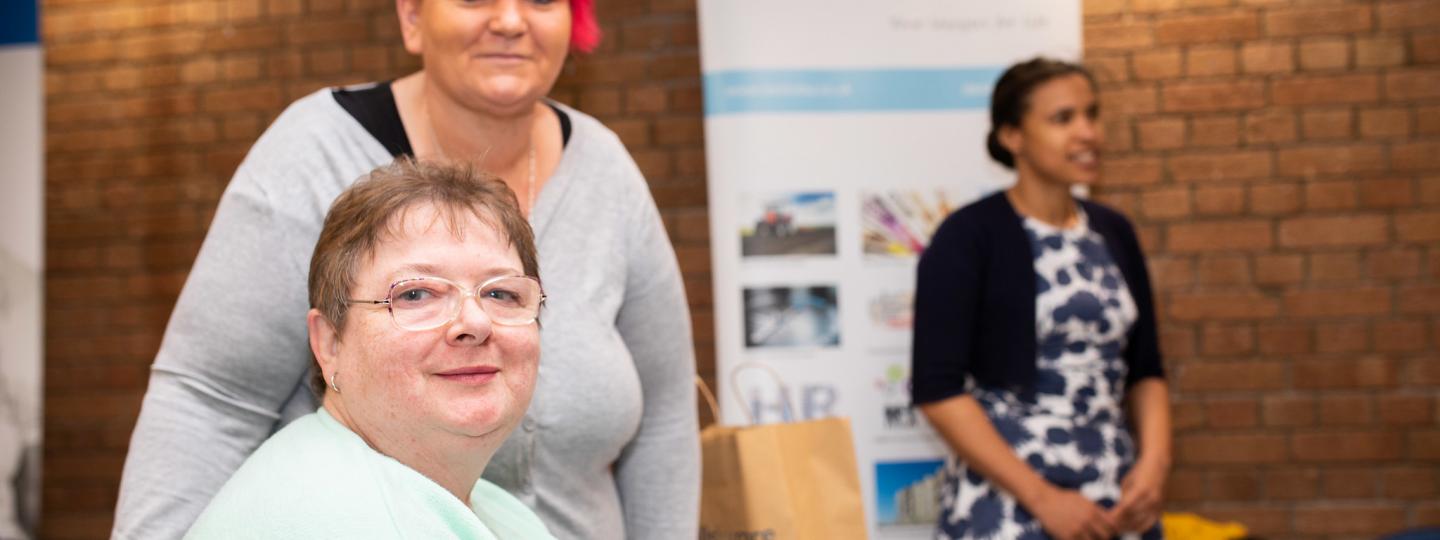 Woman smiling during healthwatch event