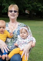Woman holding 2 children